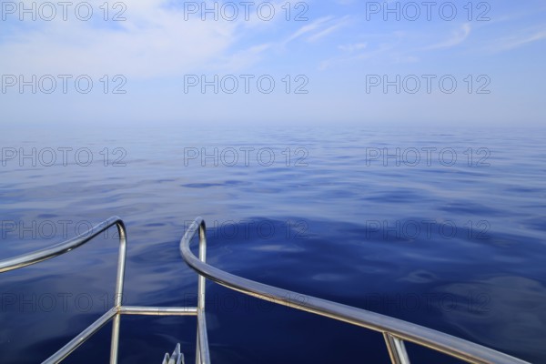 Boat sailing blue calm ocean sea bow railing in Mediterranean