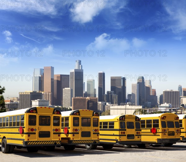 American typical school bus rear view in a row at LA skyline photo mount