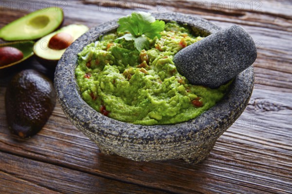 Avocado Guacamole on molcajete real Mexican traditional procedure