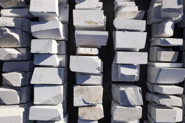 Aerial photographic documentation of a warehouse of white marble blocks ready for shipment