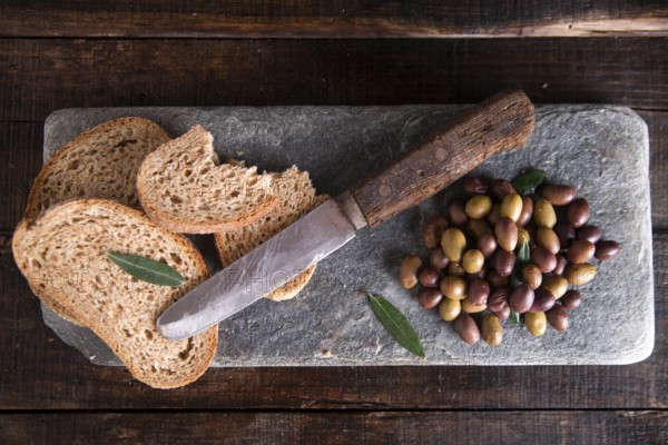 Aperitif made of bread with mixed olives in brine of Tuscany Italy