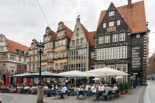 Bremen, Germany, August 6 2019: Restaurant terrace in historical centre of the medieval Hanseatic City of Bremen. Market Square, Europe