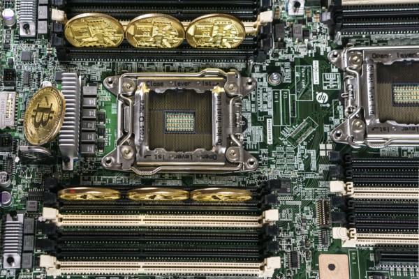 Golden Bitcoin Cryptocurrency on computer circuit board. Blockchain and security concept