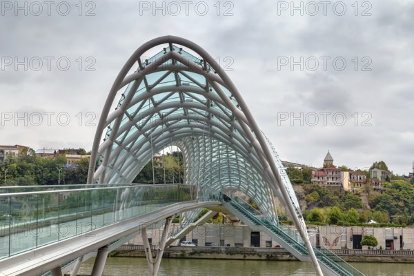 Bridge of Peace is a bow-shaped pedestrian bridge over the Kura River in downtown Tbilisi, Georgia, Asia