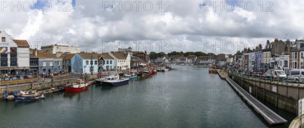 Weymouth, United Kingdom, 7 September, 2022: downtown Weymouth and fishing boats on the River Wey in Dorset, Europe