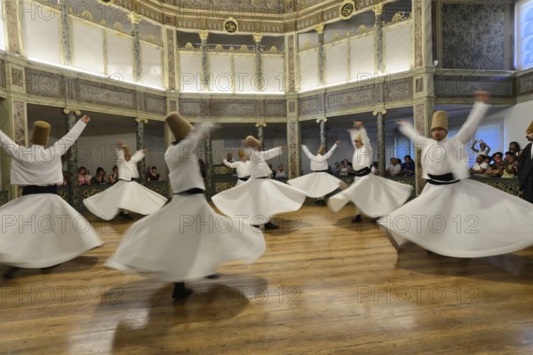 Dancing dervishes, dervish dance Sema, Mevlevihanesi Müzesi at Istiklal Caddesi, Istanbul, European part, Turkey, Asia, A group of dervishes dances synchronously in white robes on a wooden floor surrounded by spectators, Istanbul province, Dervish dancers in flowing harmony in a magnificent, light-flooded room, Istanbul Modern, Asia
