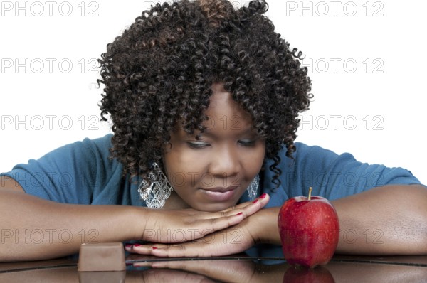 A woman trying to decide whether or not to eat healthy