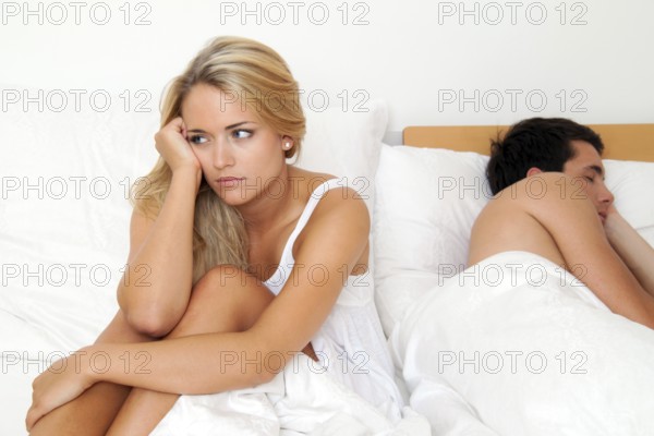 A young couple in bed having problems and crisis. Divorce and separation, A young couple in bed having problems and crisis. Divorce and separation. Austria