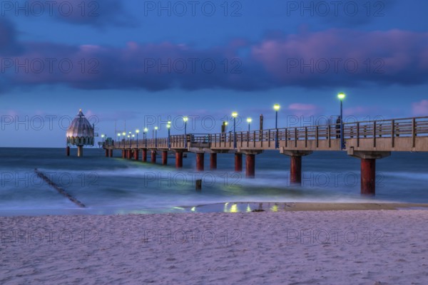 Stormy evening at the Coast of the Eastsea on an autumn day with the sea bridge at Zingst and beautiful sky. Night at the Coast of the Eastsea on an autumn day with the sea bridge at Zingst and beautiful sky