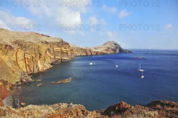 Madeira. Picturesque white yachts in the rocky gulf in the east of the island