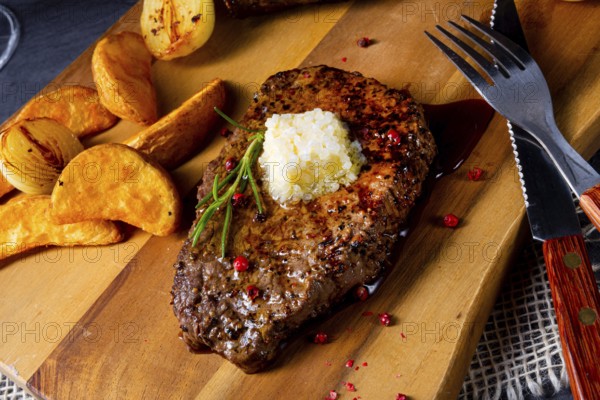 Butter beef steak with herbs and potato wedges