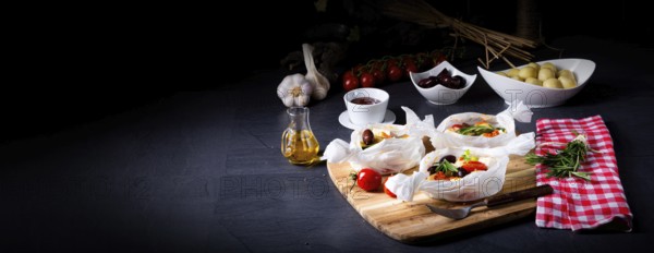 Baked dumplings with courgette, tomatoes and diced sheep's cheese