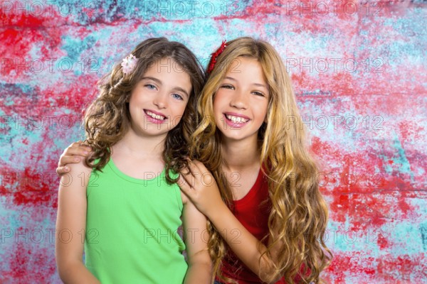Friends beautiful children girls hug together happy smiling on grunge background