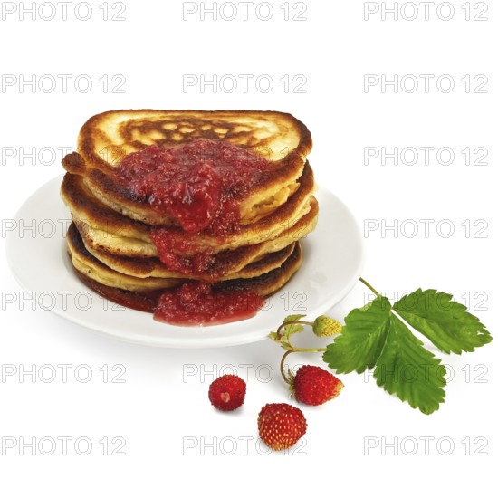 A stack of pancakes on a white plate with strawberry jam, strawberries on a branch, green leaf isolated on white background