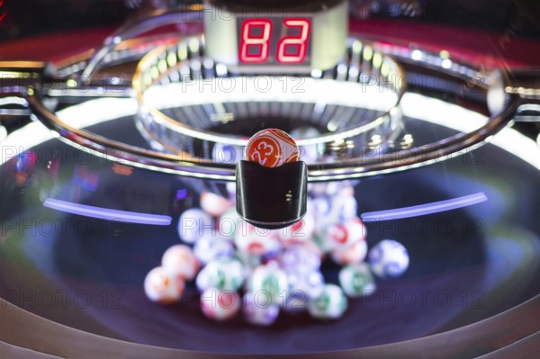 Colourful lottery balls in a rotating bingo machine. Number 23