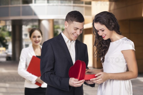 Happy young business women with a folder at the office building