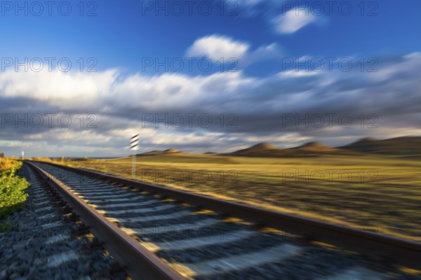 Single railway track at sunset, Central Bohemian Uplands, Czech Republic. Railway track in nature park Central Bohemian Highlands, Czech Republic, Europe