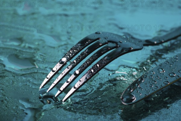 Fork and knife under the blue water