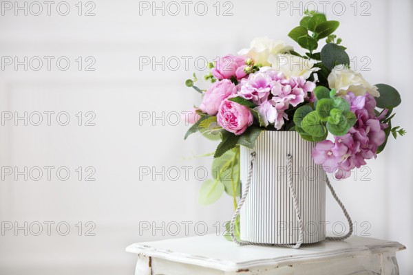 Beautiful peonies in a paper box on a white background