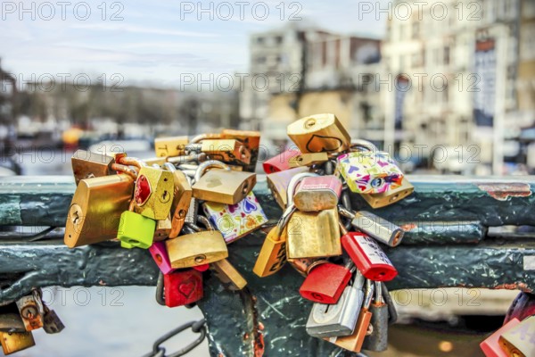 Padlocks tied on a bridge as a symbol of eternal love in an Amsterdam channel
