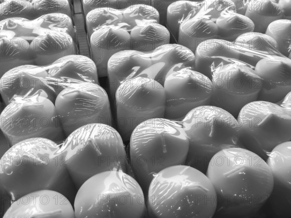 Candles in plastic wrap. Background. Pattern
