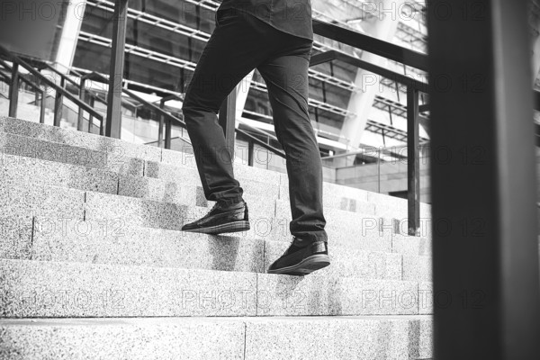 Handsome successful businessman in elegant suit outdoors walking on street in the city
