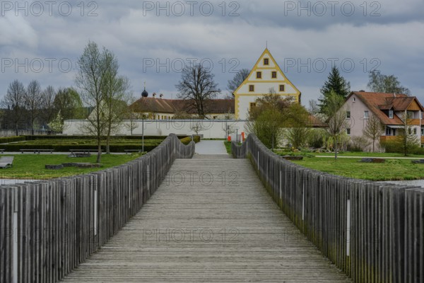 Wooden bridge leads to a historic building in a green park landscape, Tirschenreuth, Upper Palatinate, Bavaria, Germany, Europe