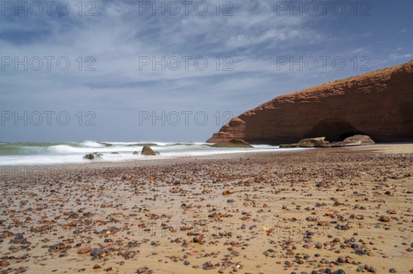 A long exposure view of the beach and rock arch at Legzira on the Atlantic Coast of Morroco