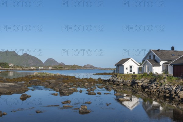 Landscape and townscape with a view over Skotnesosen Bay, Ballstad, Lofoten, Norway, Europe