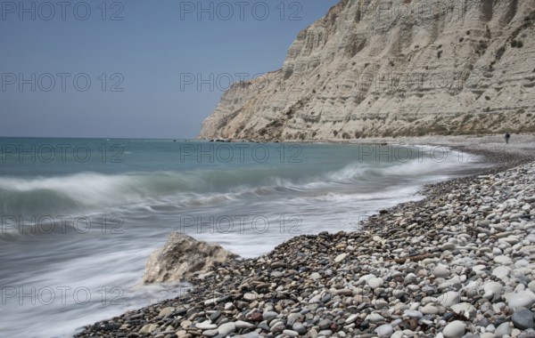 Empty pebble tropical beach under white cliffs against blue sky. Pissouri coastline Limassol Cyprus Europe