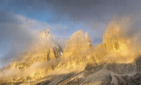 Foggy mountain landscape during sunrise of the picturesque Dolomiti at Passo Sella area in South Tyrol in Italy