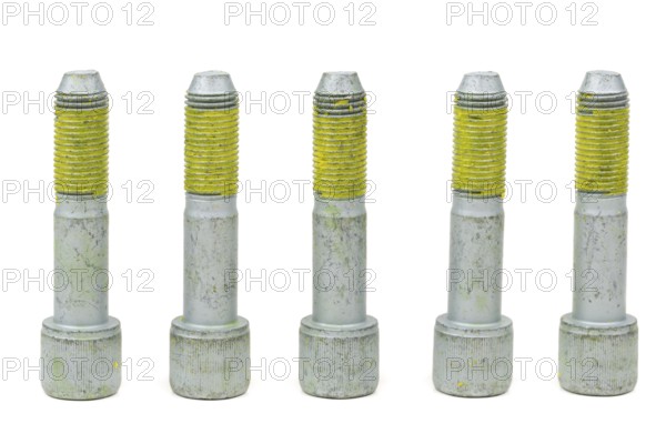 Five bolts for the car with the yellow glue on the threads. Isolate on white