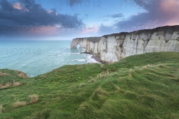 Beautiful sunrise over cliffs in Atlantic ocean, Etretat, France, Europe