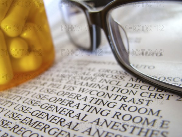 Closeup Of A Medical Hospital Bill, Prescription Medicine And Glasses