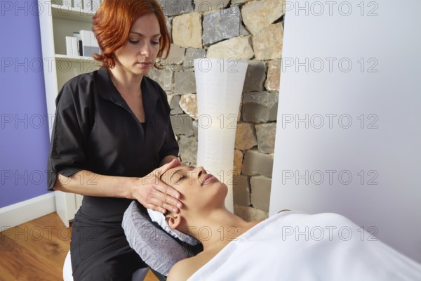 Head neck and facial massage woman with physiotherapist indoor