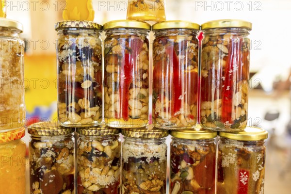 Honey with dried fruits and dried nuts - walnuts, hazelnuts, peanuts, almonds, cashews, plums, cherries, apples, figs and dates