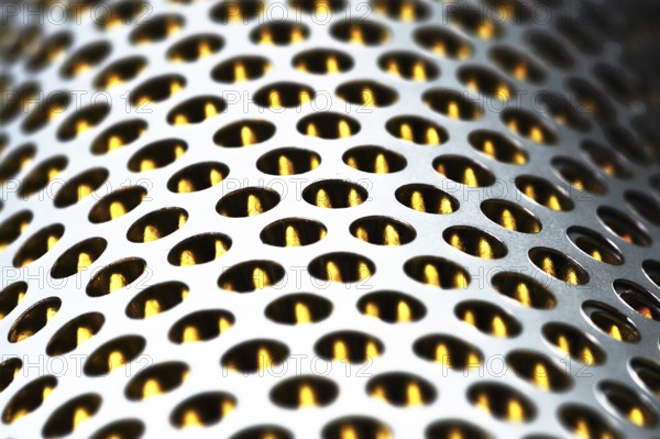 Detail of a tractor oil filter creates an industrial textured background