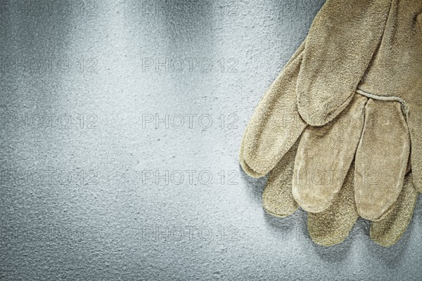 Safety gloves on concrete background construction concept