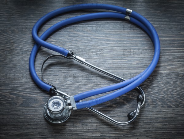 Stethoscope on vintage wooden board horizontal image