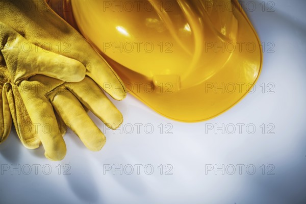 Leather protective gloves building helmet on white background