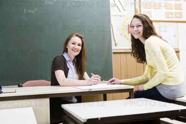 Portrait of a young female teacher and a schoolgirl in the classroom