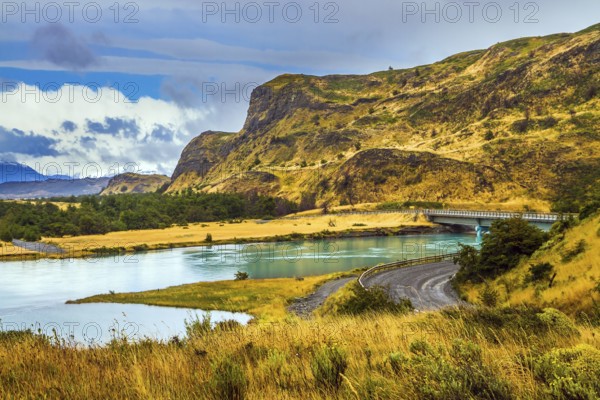 Summer in the south of Chile. Highway and bridge of Rio Paine. Torres del Paine National Park. The concept of extreme and active tourism