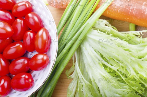Raw health vegetables on wooden kitchen table
