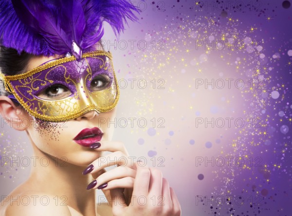 Beautiful woman with dramatic mekaup and pruple lipstick wearing puprle mask. Light background. Golden, Toronto, Canada, North America