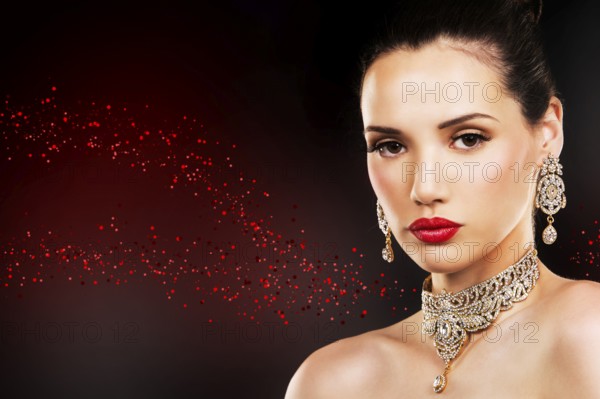 Beautiful woman with dark makeup and red lipstick posing on black background, Toronto, Canada, North America