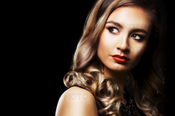 Beautiful woman with dark makeup and red lipstick posing on black background, Toronto, Canada, North America