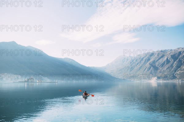 Kayaks in the lake. Tourists kayaking on the Bay of Kotor, near the town of Perast in Montenegro. Aerial Photo drone
