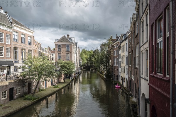 Utrecht, Netherlands, August 4, 2016: Canal in historic centre of Utrecht. Ancient city centre features many buildings and structures several dating as far back as the High Middle Ages