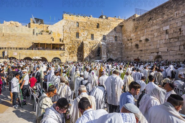 Exciting ceremony at the Western Wall of the Temple. The blessing of the Cohanim. Jerusalem. Jews praying wrapped in festive white Talit. The concept of pilgrimage, religious and photo tourism