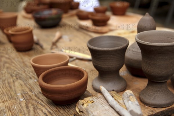 Clay pottery ceramics on vintage table at artisan studio